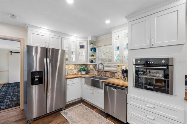 a kitchen with stainless steel appliances kitchen island a refrigerator and a stove