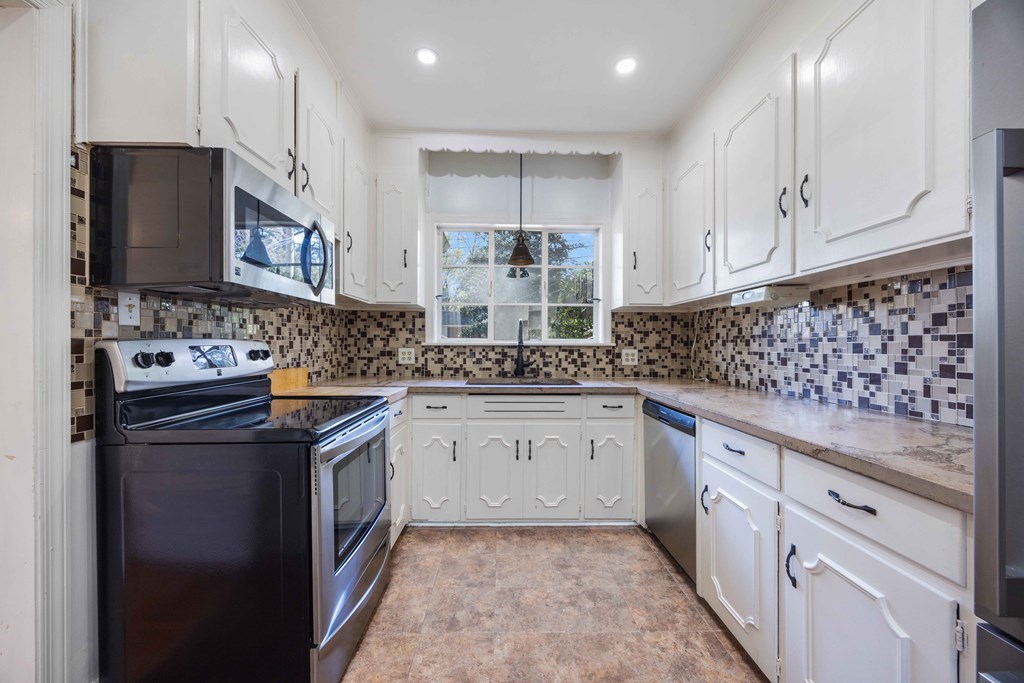 1712 Marilon Drive Columbus, GA 31906 - Photo 6 of 15 a kitchen with granite countertop a sink stove and cabinets