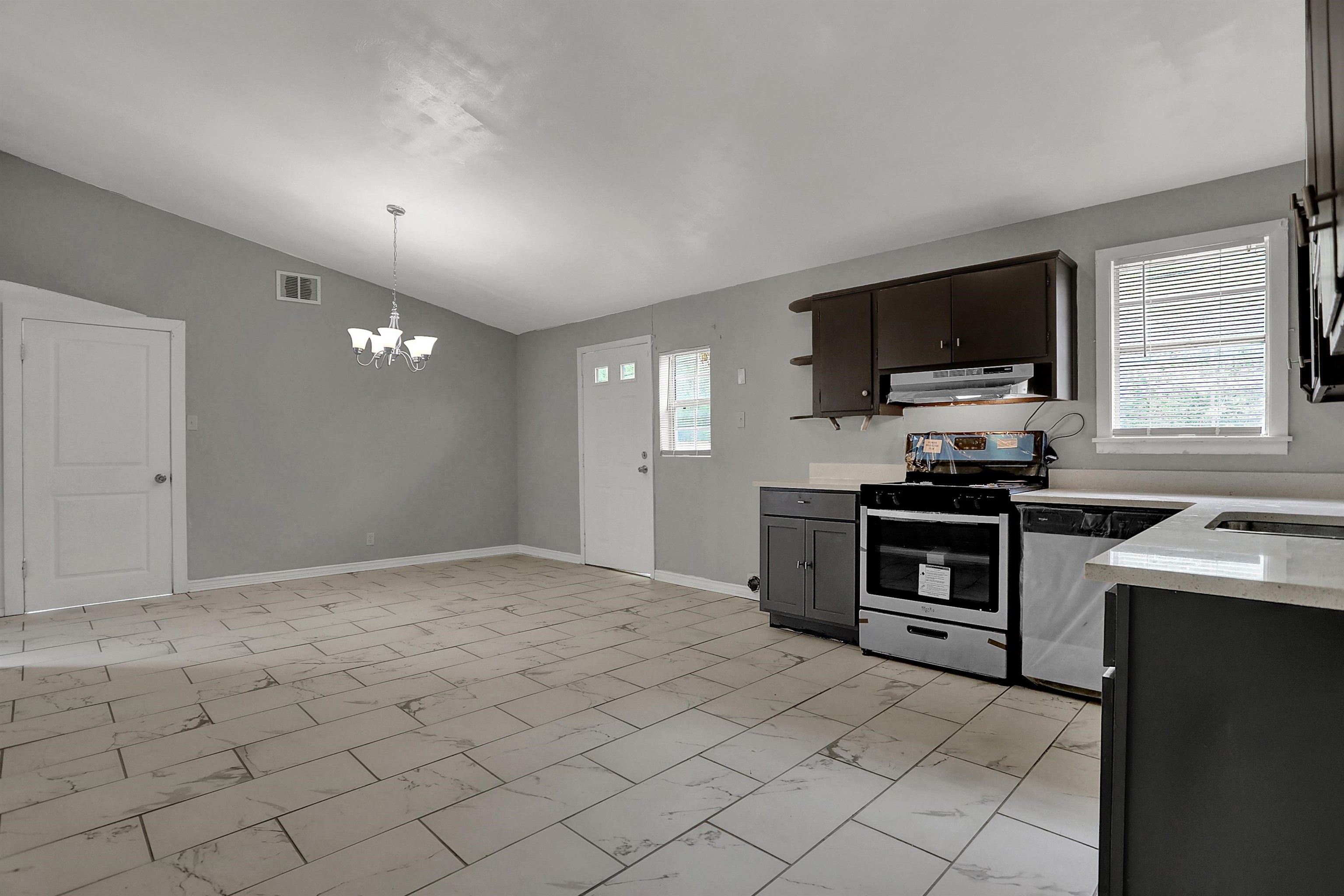 4477 Neely Road Memphis, TN 38109 - Photo 13 of 25 a kitchen with stainless steel appliances a stove sink microwave and cabinets