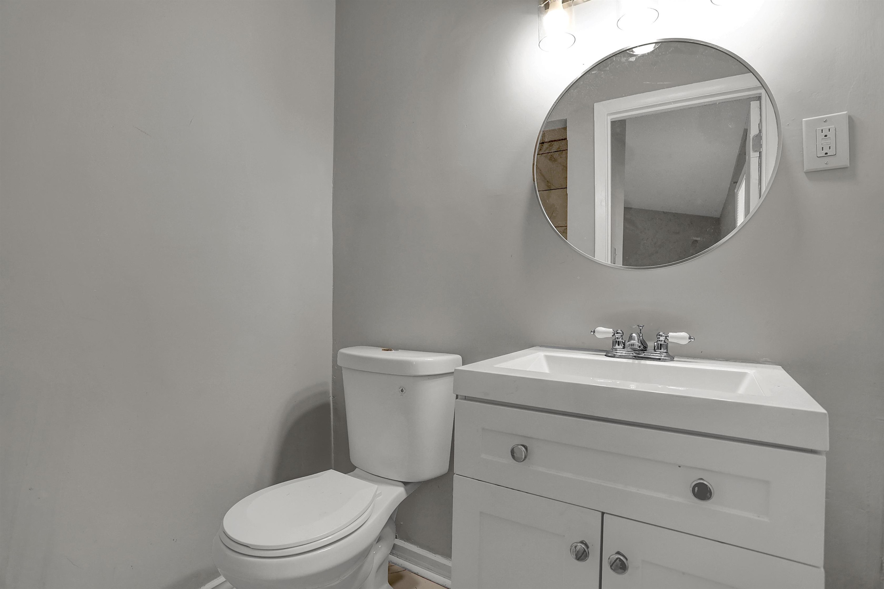 4477 Neely Road Memphis, TN 38109 - Photo 21 of 25 a bathroom with a toilet a sink and mirror