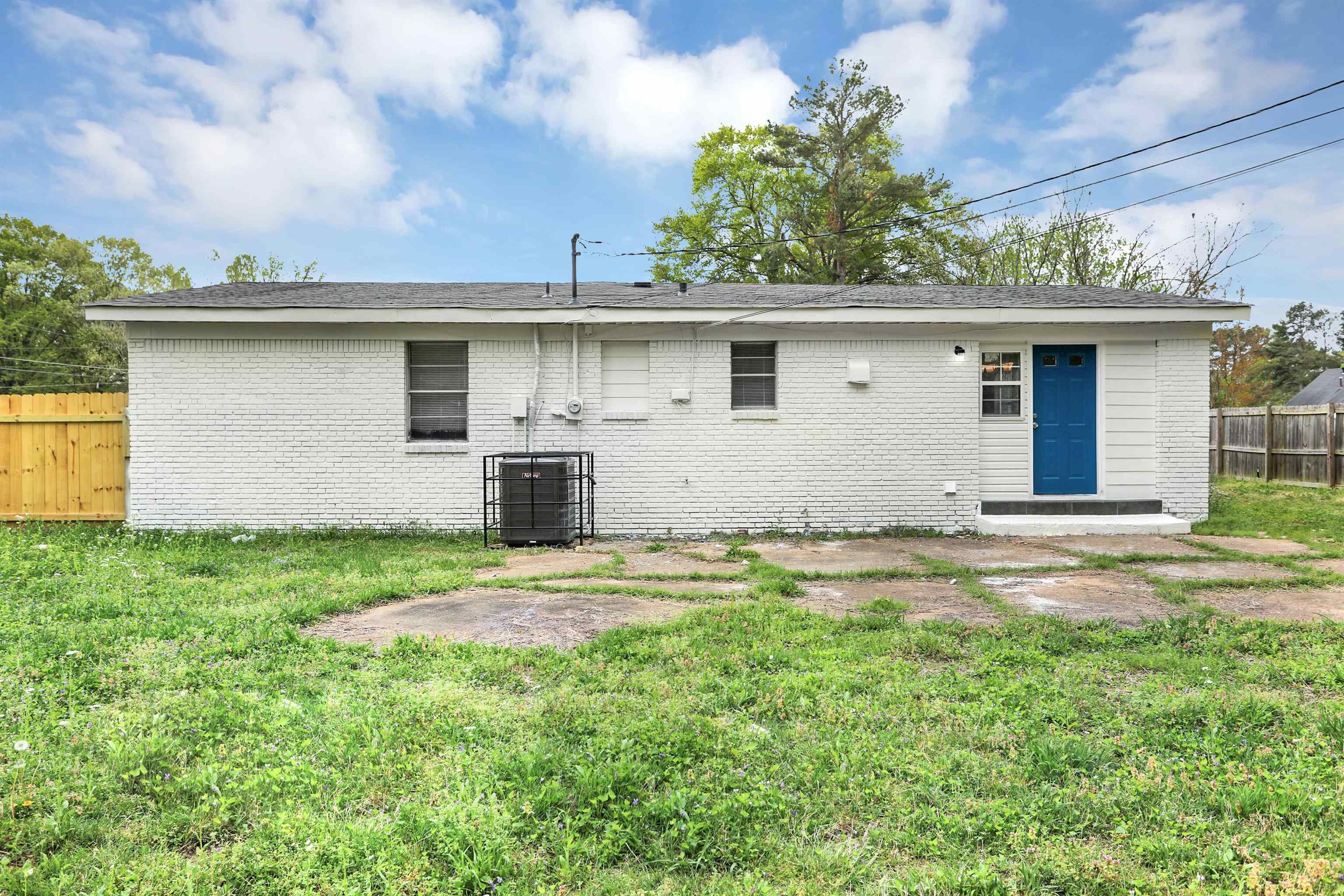 4477 Neely Road Memphis, TN 38109 - Photo 23 of 25 a backyard of a house with large trees and barbeque oven