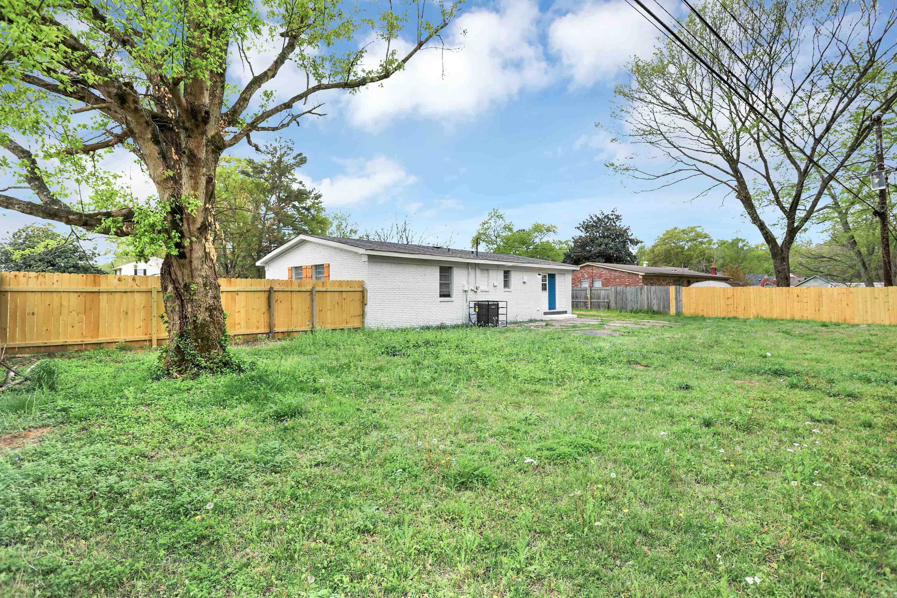 4477 Neely Road Memphis, TN 38109 - Photo 24 of 25 a view of a house with backyard and a tree