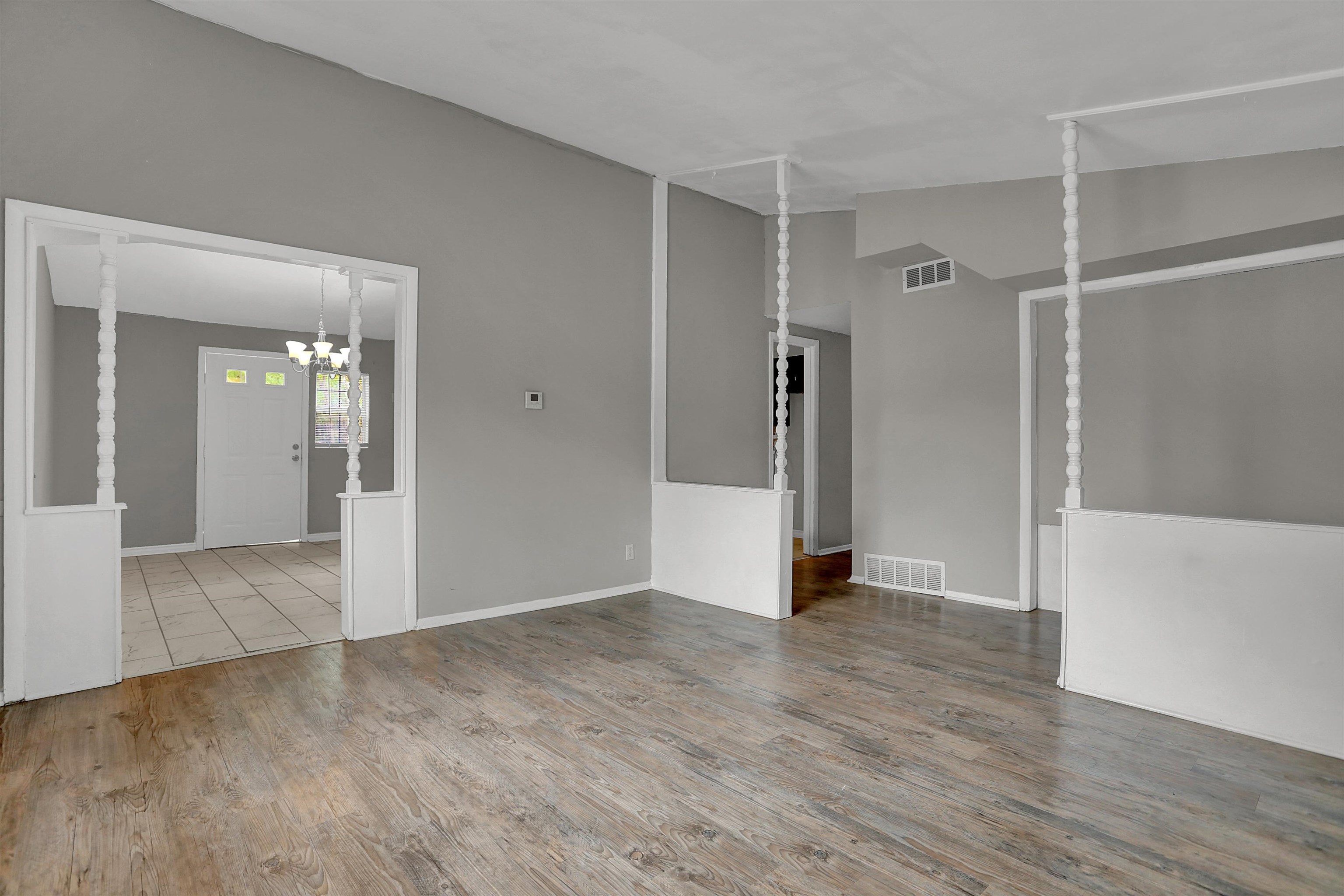 4477 Neely Road Memphis, TN 38109 - Photo 10 of 25 a view of an empty room with wooden floor and a bathroom