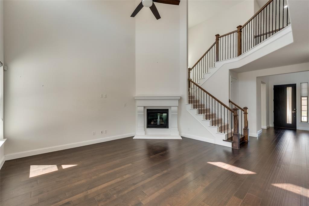 16476 Ryder Rock Road Frisco, TX 75033 - Photo 10 of 40 Great room with wrought iron and wood staircase