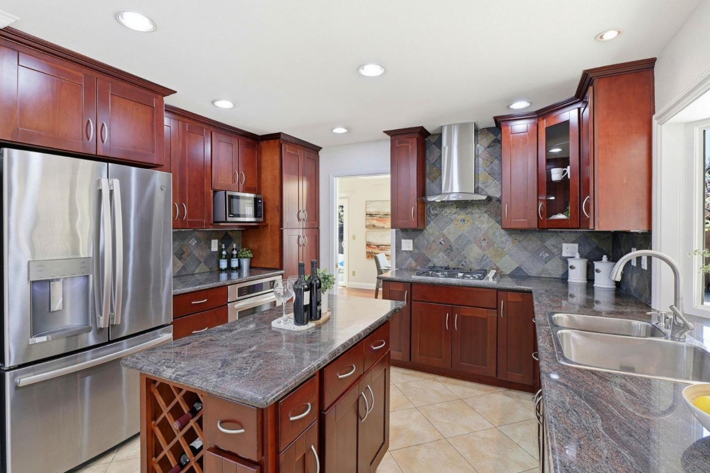 6207 McAbee Road San Jose, CA 95120 - Photo 12 of 48 a kitchen with stainless steel appliances granite countertop a sink refrigerator and cabinets