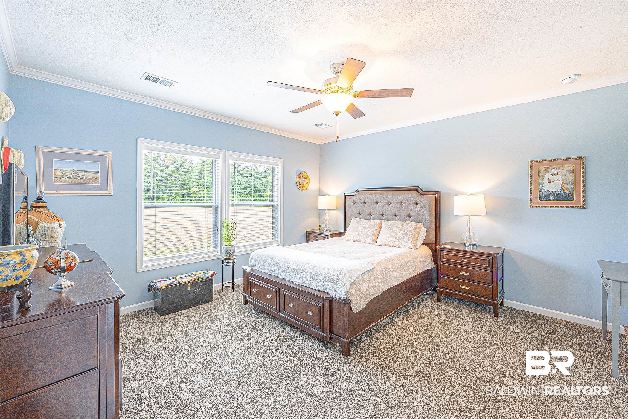 16000 John Bauer Road Summerdale, AL 36580 - Photo 18 of 34 Bedroom featuring visible vents, a textured ceiling, and light colored carpet