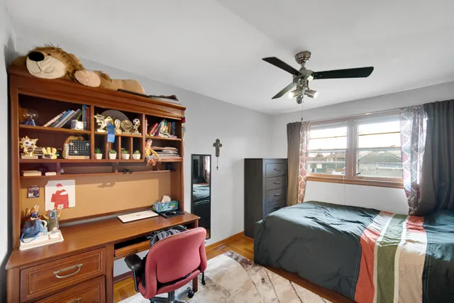 a bedroom with a bed and a bookshelf