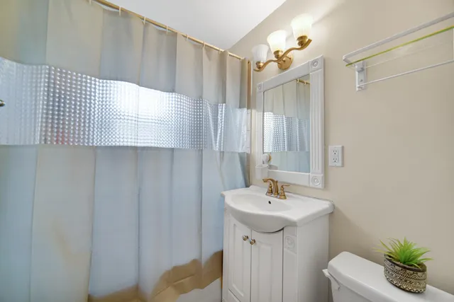 a bathroom with a sink a mirror and a shower