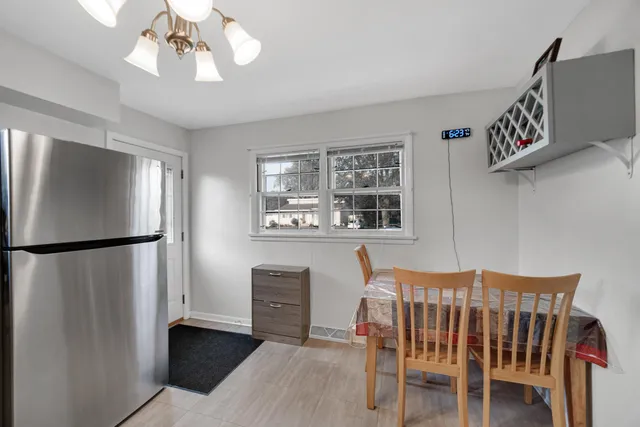 a bedroom with furniture a chandelier and a window