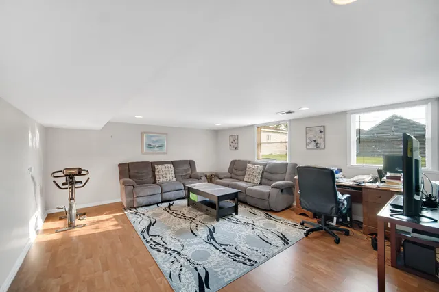 a living room with furniture rug and wooden floor