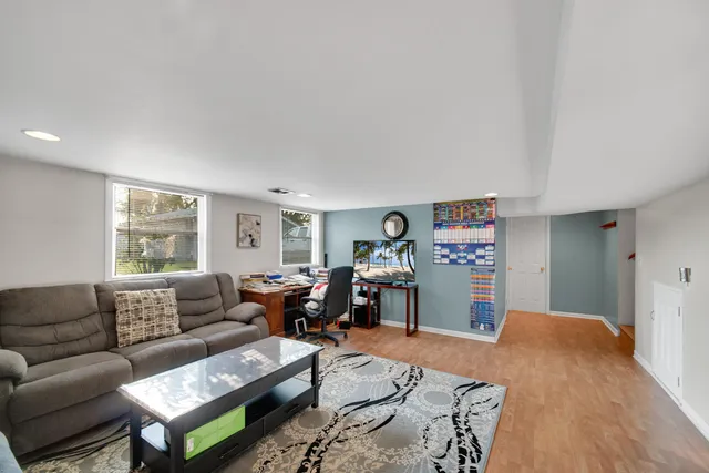 a living room with furniture and a wooden floor
