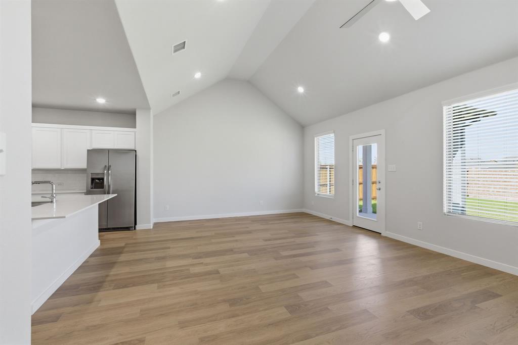 637 Sierra Ridge Lavon, TX 75166 - Photo 5 of 26 a view of an empty room with window and wooden floor