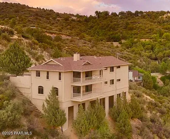 a front view of a house with a yard and garden