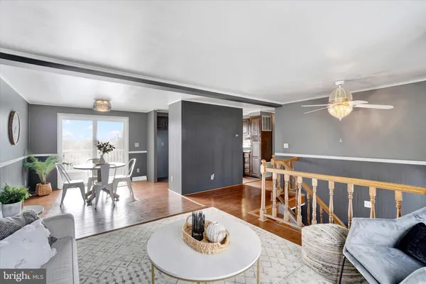 a living room with furniture and a dining table