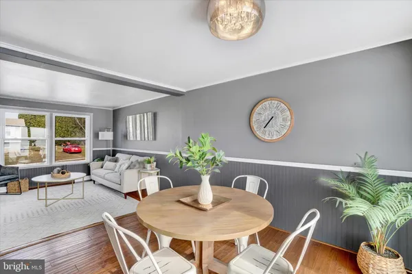 a dining room with furniture and wooden floor