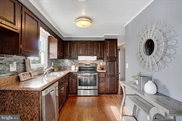 a kitchen with a sink appliances and cabinets