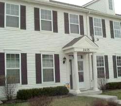 a view of a brick house with large windows
