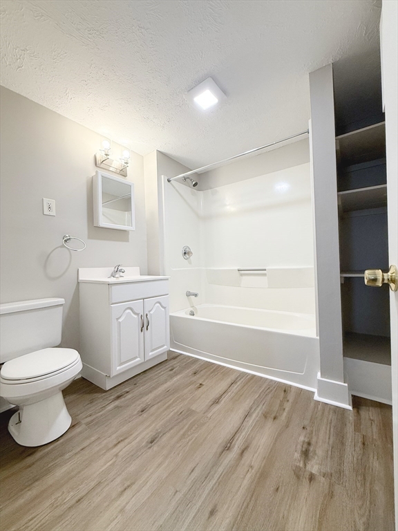25 Kinsley Street, Unit I Nashua, NH 03060 - Photo 4 of 7 a bathroom with a sink toilet vanity and tub