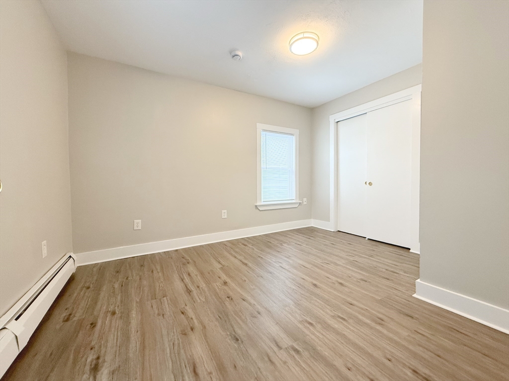 25 Kinsley Street, Unit I Nashua, NH 03060 - Photo 7 of 7 an empty room with wooden floor and windows