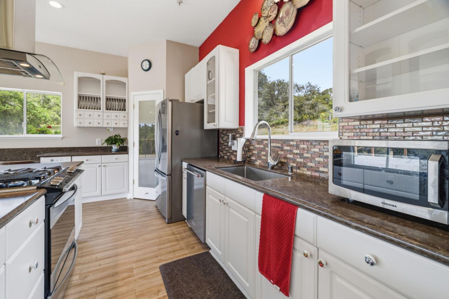 19269 Mallory Canyon Road, Unit D Salinas, CA 93907 - Photo 12 of 77 a kitchen with stainless steel appliances granite countertop a stove a sink and a refrigerator