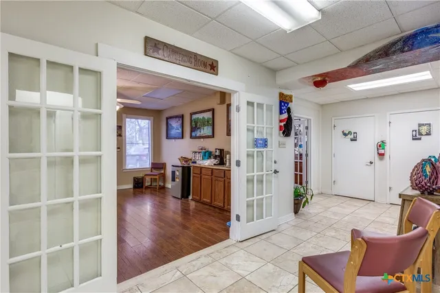 a view of a livingroom with furniture and a window