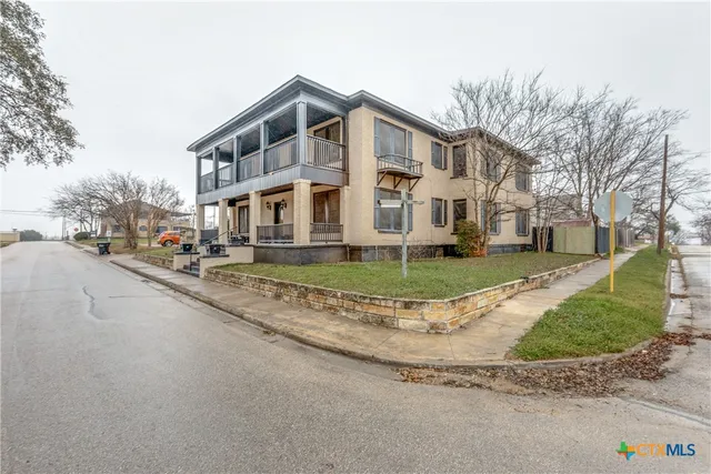 a front view of residential houses with yard