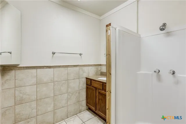 a bathroom with a shower and a sink