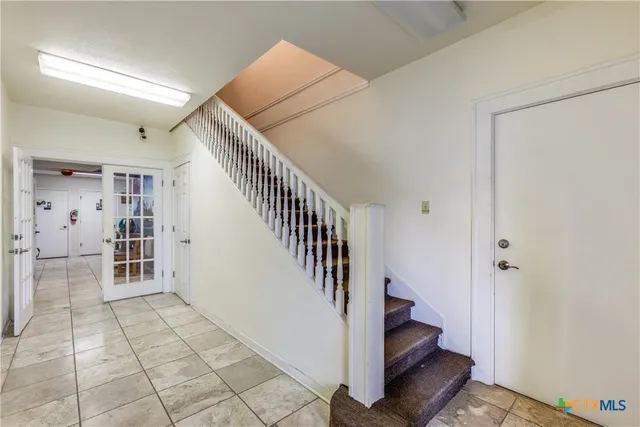 a view of entryway and hall with a rug