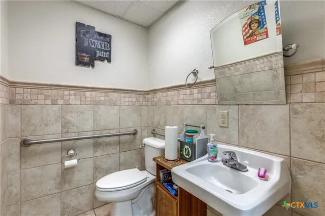 a bathroom with a sink toilet and a shower