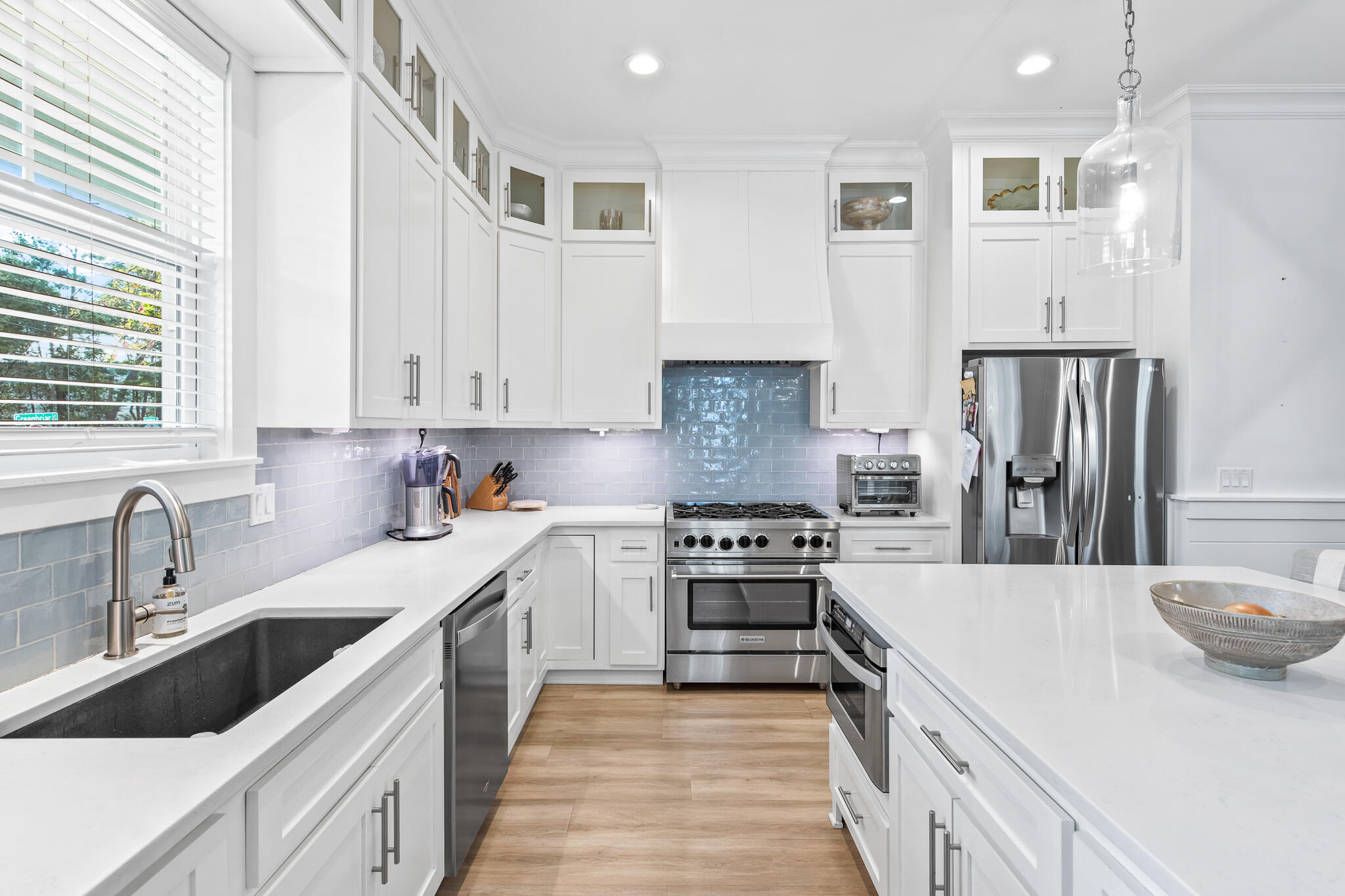 a kitchen with a sink stove and refrigerator