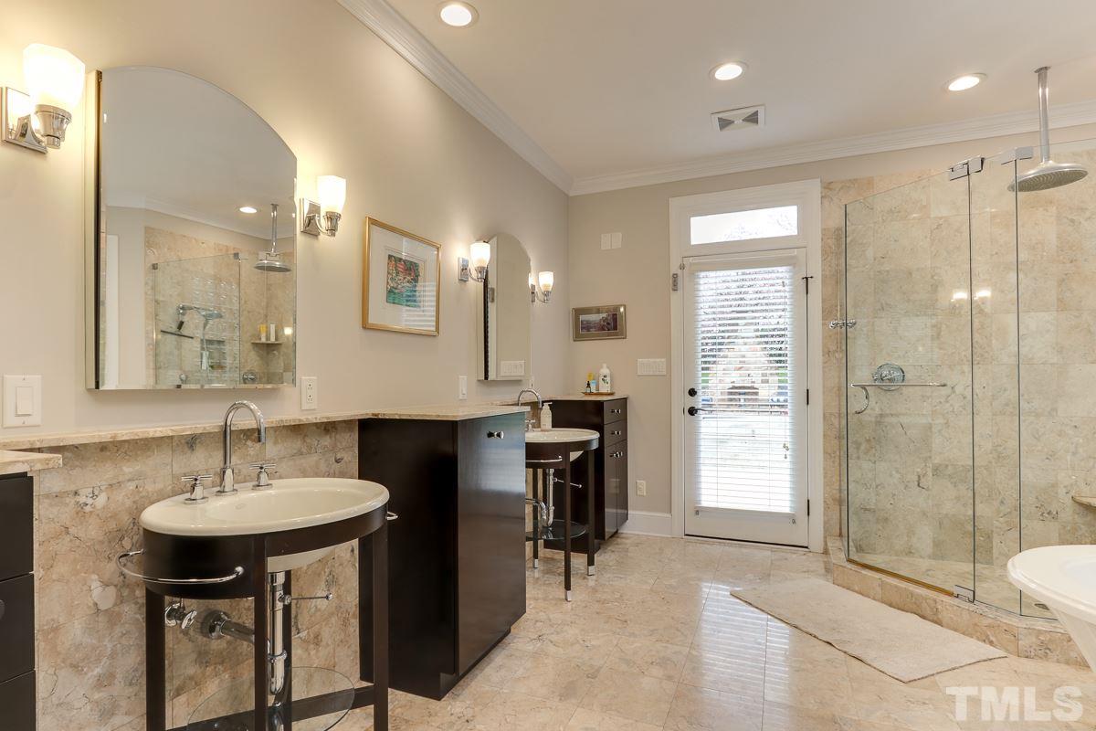 2001 Malvern Court Raleigh, NC 27615 - Photo 14 of 25 a spacious bathroom with a sink shower and a mirror