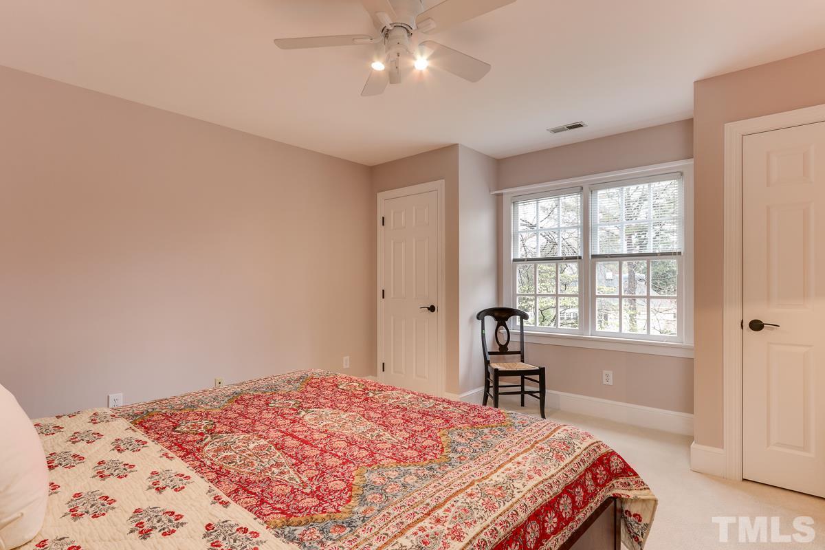 2001 Malvern Court Raleigh, NC 27615 - Photo 23 of 25 a bedroom with a bed and a window with a chair