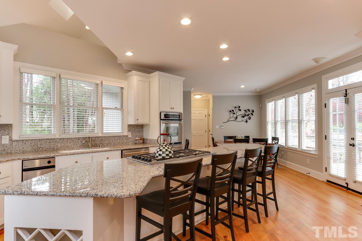 2001 Malvern Court Raleigh, NC 27615 - Photo 9 of 25 a kitchen with granite countertop kitchen island cabinets and dining table