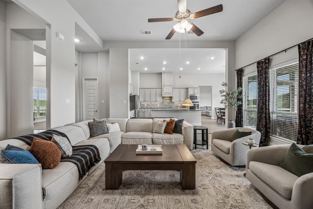 1581 Lynx Loop Forney, TX 75126 - Photo 11 of 38 The living room is open to the kitchen creating a large great room