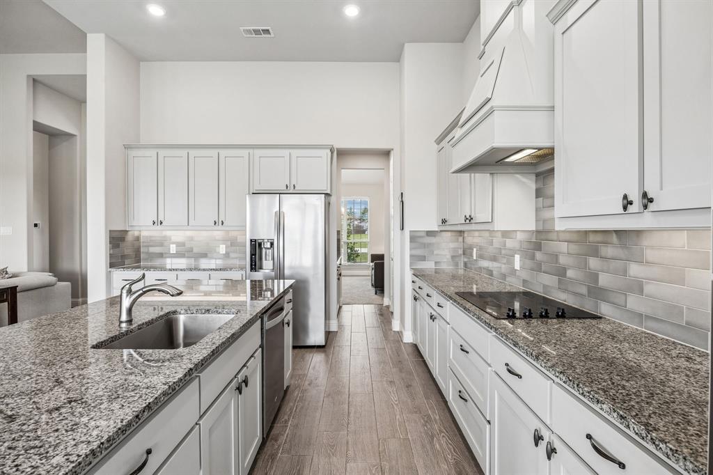 1581 Lynx Loop Forney, TX 75126 - Photo 14 of 38 Here you can see the sleek smooth cooktop and the butler's pantry