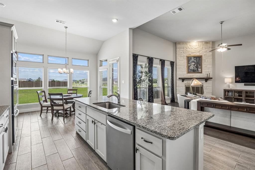 1581 Lynx Loop Forney, TX 75126 - Photo 38 of 38 The open floor plan connects the living room, kitchen and breakfast area.