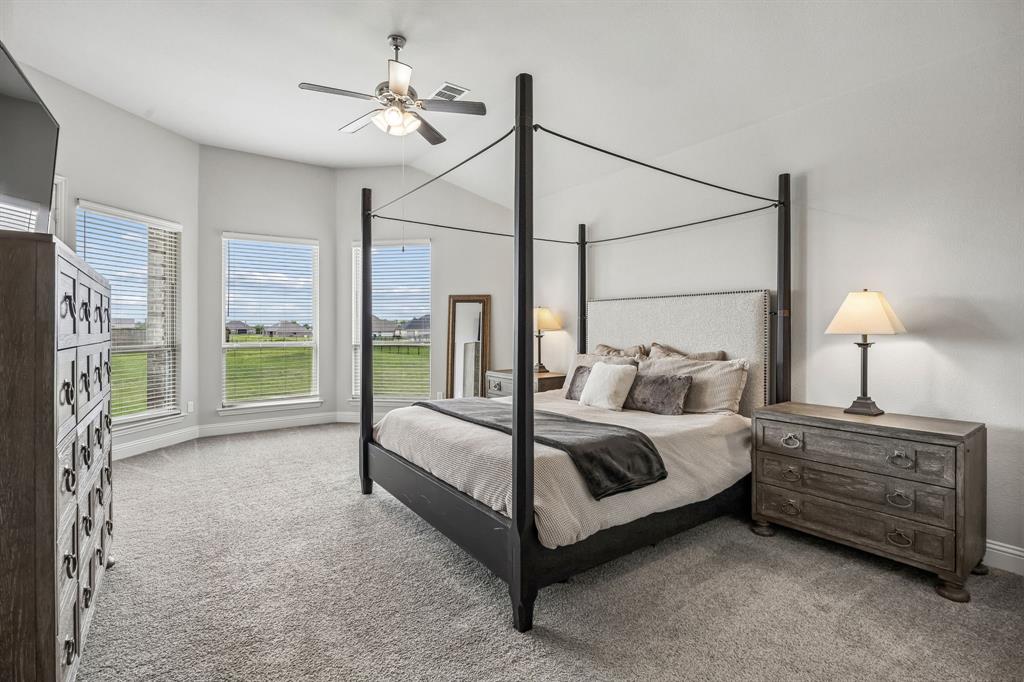 1581 Lynx Loop Forney, TX 75126 - Photo 18 of 38 Carpeted bedroom featuring a ceiling fan and view of the backyard