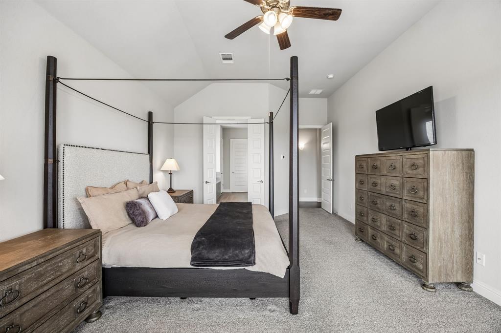 1581 Lynx Loop Forney, TX 75126 - Photo 19 of 38 Bedroom with light carpet, ceiling fan, and vaulted ceiling