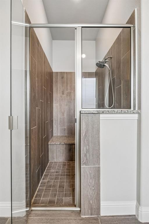 1581 Lynx Loop Forney, TX 75126 - Photo 23 of 38 Bathroom with a walk in shower and wood tiled floors