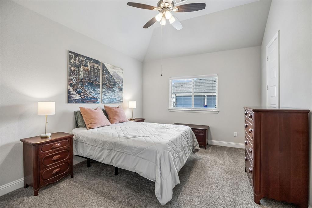 1581 Lynx Loop Forney, TX 75126 - Photo 29 of 38 Bedroom featuring lofted ceiling, carpet floors, and ceiling fan