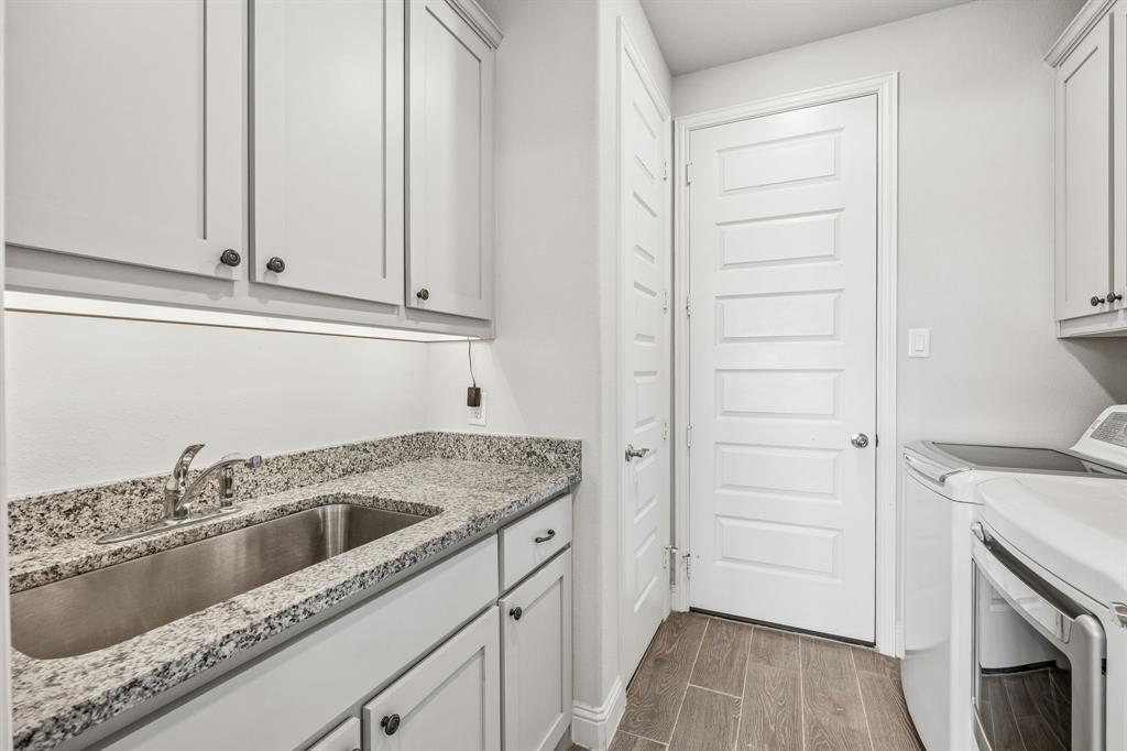 1581 Lynx Loop Forney, TX 75126 - Photo 31 of 38 Laundry room with cabinet space,undercounter lighting and utility sink. Connects the three car garage to the secondary living area.