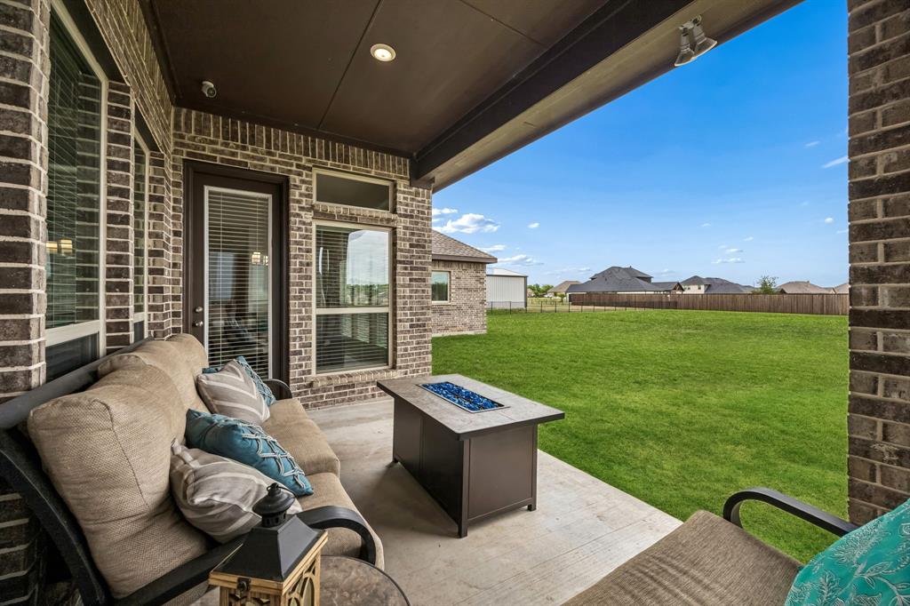 1581 Lynx Loop Forney, TX 75126 - Photo 32 of 38 Fenced backyard featuring a fire pit and a patio area