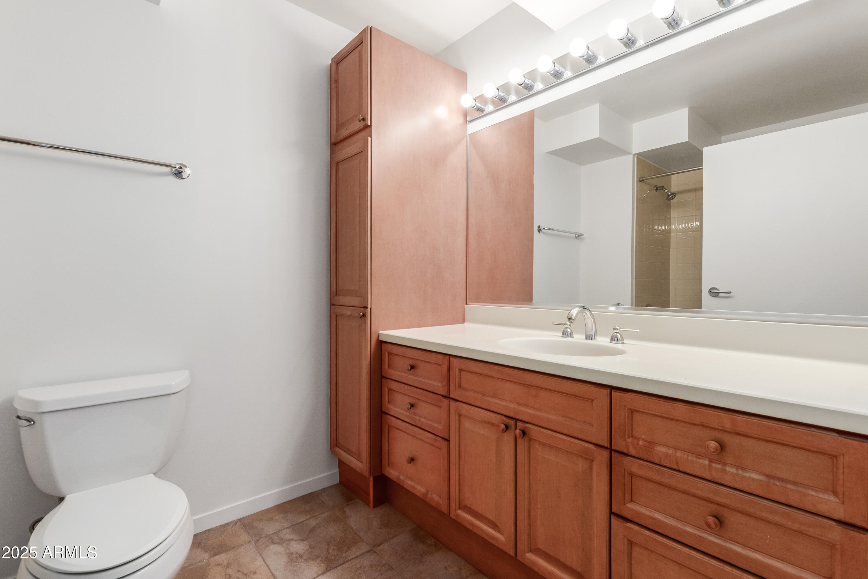 4808 North 24th Street, Unit 1005 Phoenix, AZ 85016 - Photo 19 of 34 a bathroom with a toilet a sink and mirror