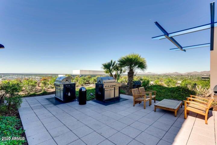 4808 North 24th Street, Unit 1005 Phoenix, AZ 85016 - Photo 22 of 34 a living room with furniture and a flat screen tv
