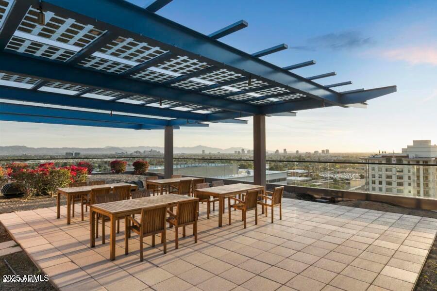 4808 North 24th Street, Unit 1005 Phoenix, AZ 85016 - Photo 23 of 34 a view of a patio with a table and chairs