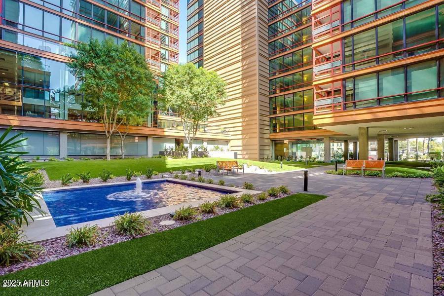 4808 North 24th Street, Unit 1005 Phoenix, AZ 85016 - Photo 30 of 34 a front view of a house with a yard