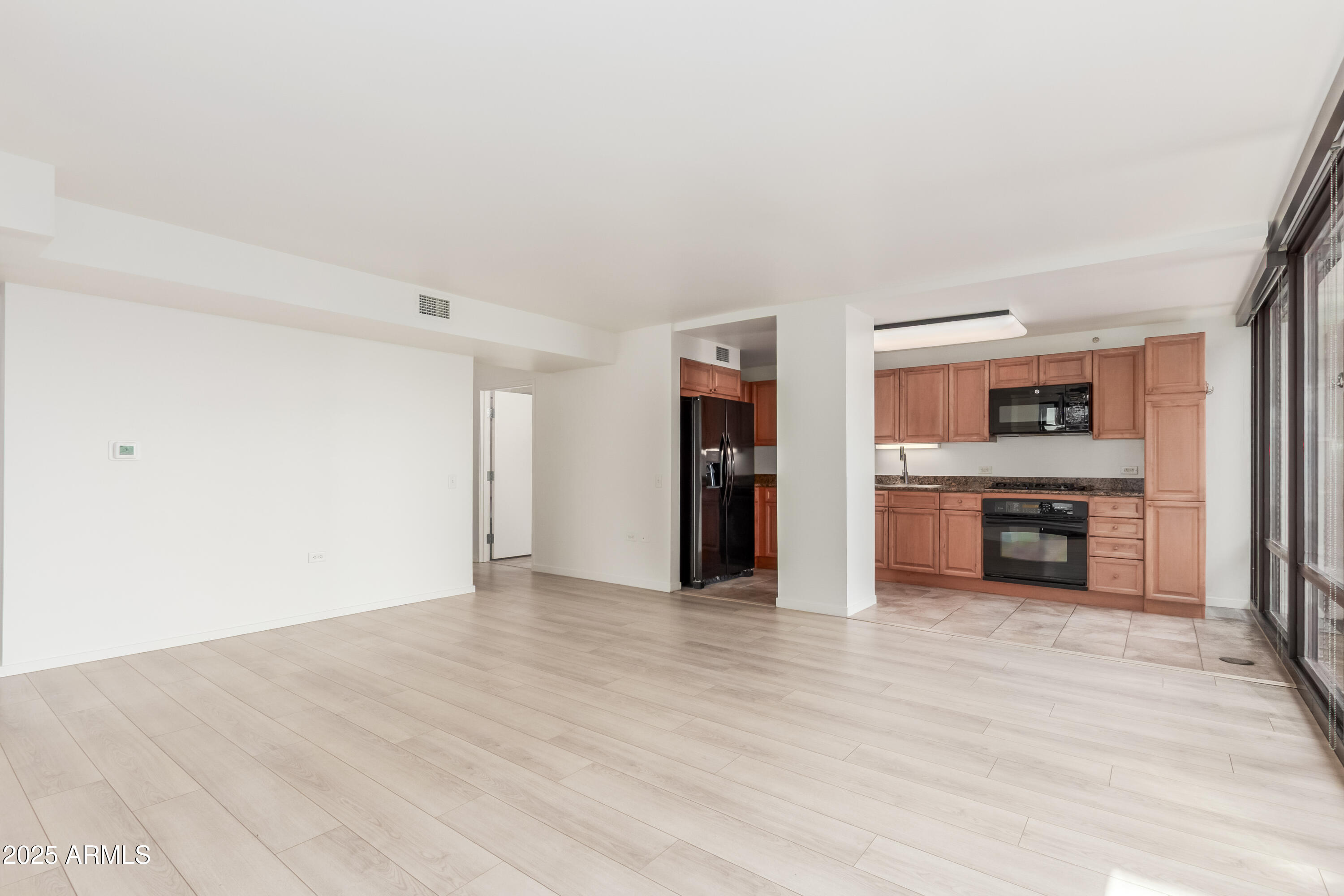 4808 North 24th Street, Unit 1005 Phoenix, AZ 85016 - Photo 5 of 34 a view of a kitchen with a sink a refrigerator and a stove top oven