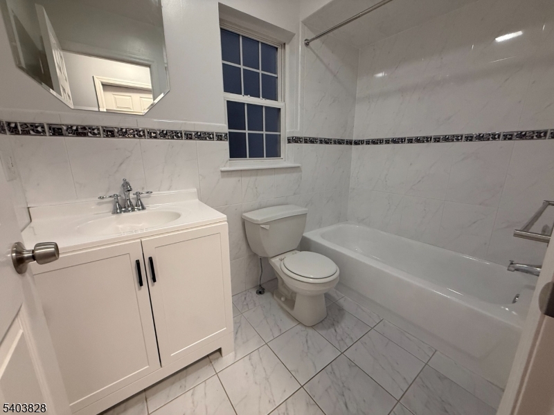 527 4th Avenue, Unit 1 Elizabeth, NJ 07202 - Photo 12 of 21 a bathroom with a sink a toilet and shower