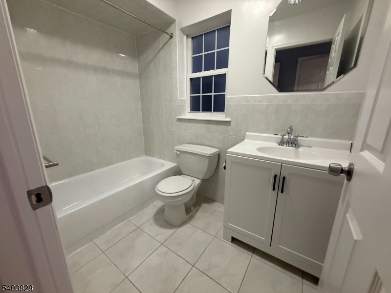 527 4th Avenue, Unit 1 Elizabeth, NJ 07202 - Photo 18 of 21 a bathroom with a sink a toilet and shower