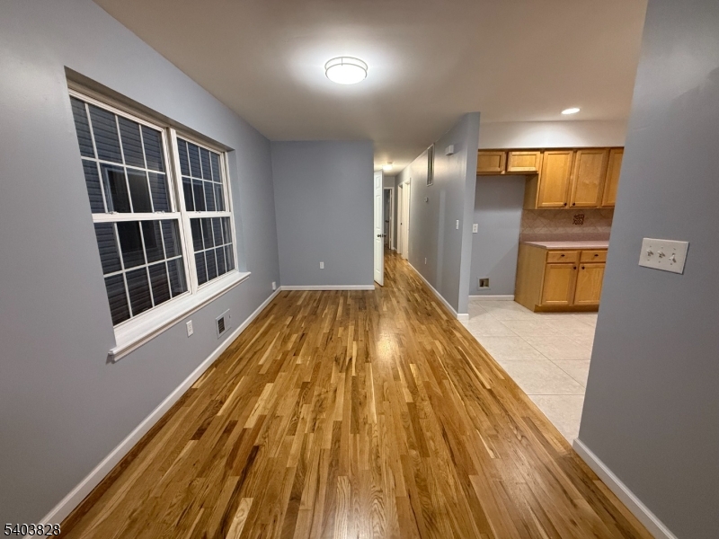 527 4th Avenue, Unit 1 Elizabeth, NJ 07202 - Photo 6 of 21 a view of a kitchen with a fridge and wooden floor